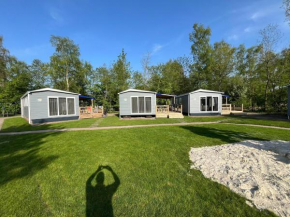 Chalet with play equipment, on a holiday park